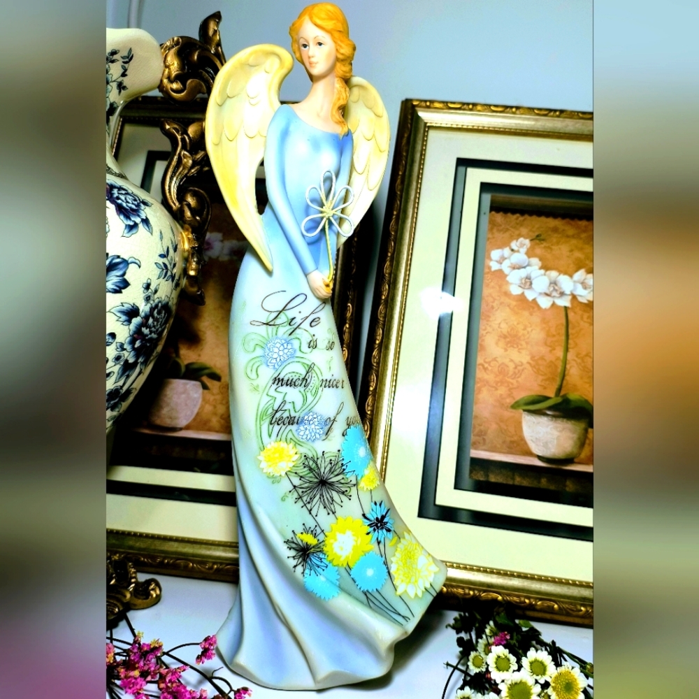 Elegant angel figurine. Features a blue dress with yellow floral accents. Perfec